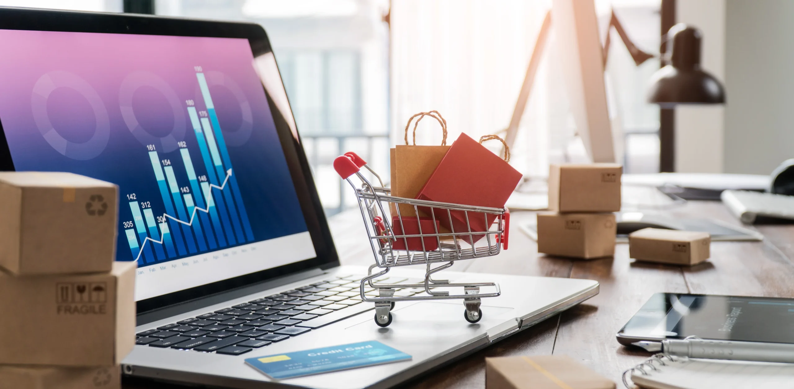 E-commerce shopping cart with laptop and card checkout